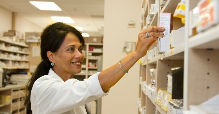 Apothekerin sortiert Medikamente in einer Apotheke